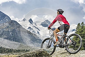 Nice Senior Woman on electric bicycle in Engadin valley, Switzerland