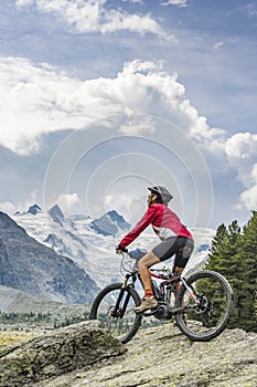 Nice Senior Woman on electric bicycle in Engadin valley, Switzerland