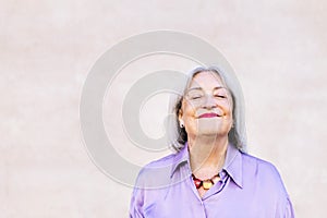 nice senior woman smiling with eyes closed