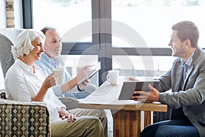 NIce smiling aged couple having meeting in the cafe