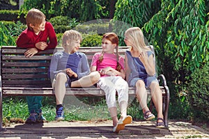 Nice smiling children sitting on the bench photo