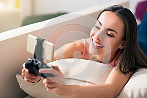 Nice smiling woman resting on the couch