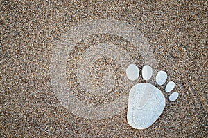 Nice stone made footprint on the sand shore, background.