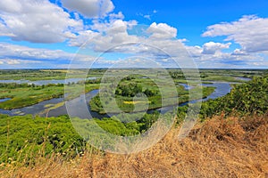 Nice summer landscape with hill slope over delta river