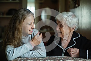Nice teen girl with her old grandmother. Family.