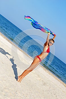 Nice teen girl standing on the beach