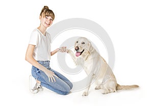 Nice teen woman and her beautiful Golden Retriever dog over white background