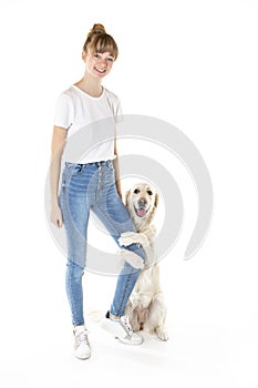 Nice teen woman and her beautiful Golden Retriever dog over white background