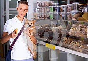 Nice teenage boy choosing dog treats