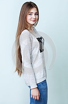 Nice teenage girl in gray shirt and jeans