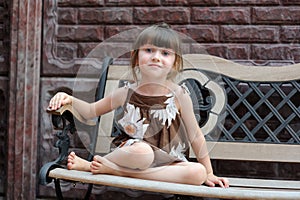 Nice toddler girl on bench photo