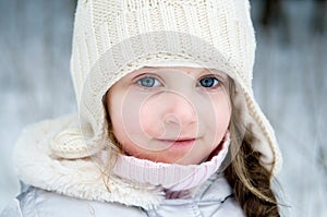 Nice toddler girl in white winter hat