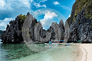 Nice tropical beach with stranded Filipino bankga boats