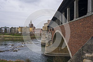 Nice view of bridge over Ticino river in Pavia at overcast day