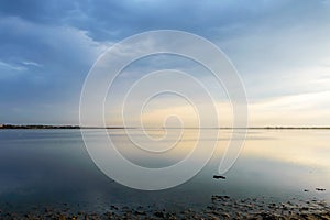 Nice view of the estuary. Sunset over the sea. Calm sea surface