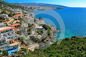 Nice view of the sea and the town of Dobra Voda. Houses with red roofs, stones, green forests and hills. Montenegro, Balkans