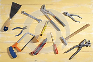 Nice view of tools for work in the home on yellow wooden background