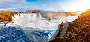 Nice views of the bright sunlit powerful Godafoss cascade. Location Skjalfandafljot river, Iceland, Europe. Beauty world