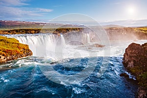 Nice views of the bright sunlit powerful Godafoss cascade. Location Skjalfandafljot river, Iceland, Europe. Beauty world photo