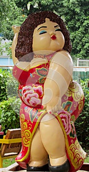 Nice welcoming colorful figure in asian garden