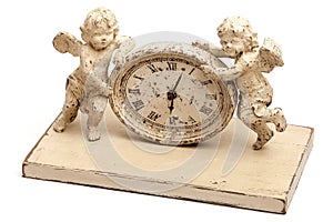 Nice white old fashioned vintage clock with two baby angels or cupids from both sides.