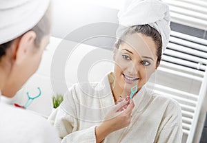 Nice woman cleaning her teeth