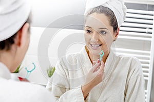 Nice woman cleaning her teeth