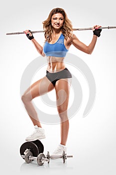 Nice woman doing workout with big dumbbell, retouched