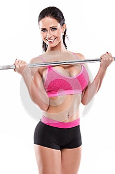 Nice woman doing workout with big dumbbell, retouched