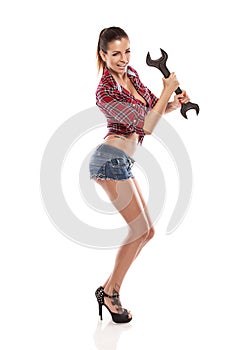 Nice woman mechanic holding wrench