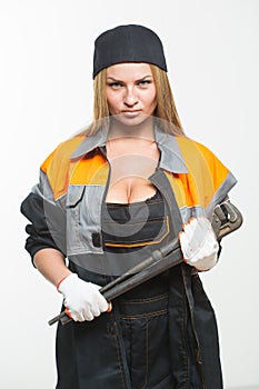 Nice woman mechanic holding wrench isolated over white background