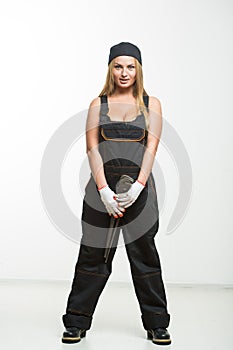 Nice woman mechanic holding wrench isolated over white background