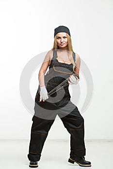 Nice woman mechanic holding wrench isolated over white background