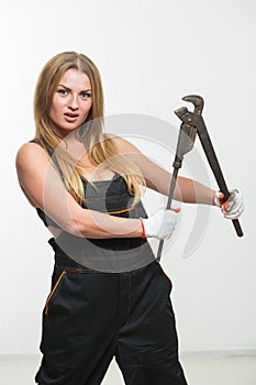 Nice woman mechanic holding wrench isolated over white background