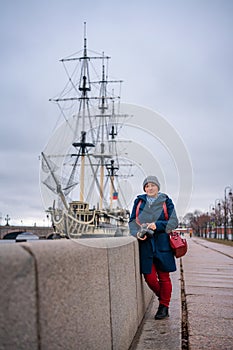 Nice woman on the waterfront near the ship