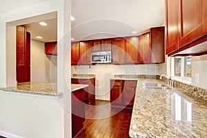 Nice wooden kitchen room interior with granite counter tops