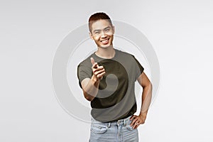 Nice work, good job. Portrait of young cheerful asian man pointing finger at camera and smiling satisfied, congratulate