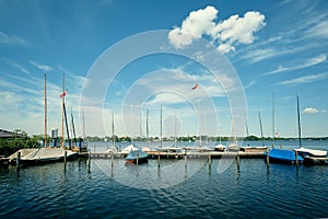 Nice yachts and boats on sunny summer day at the Alster lake in Hamburg, Germany