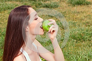 Nice young girl eating apple