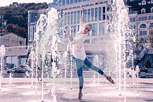 Nice young woman feeling the energy of water