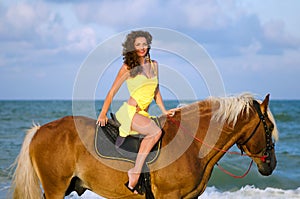 Nice young woman riding a horse
