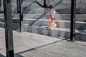 Nice young woman running down the stairs