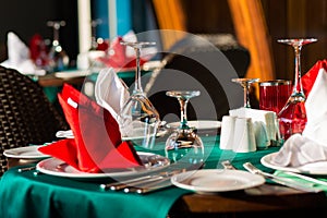 Nicely decorated table appointments with beautiful decor with plates and serviettes. The elegant dinner table