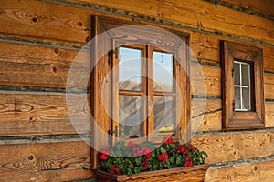 Nicely decorated window of a log cabin house.