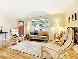 Nicely furnished living room with entryway red door and hardwood