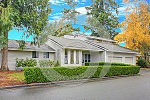 Nicely remodeled home exterior with boxwood hedge