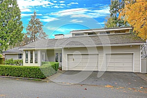 Nicely remodeled home exterior with boxwood hedge