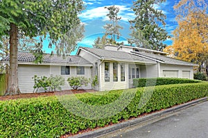 Nicely remodeled home exterior with boxwood hedge