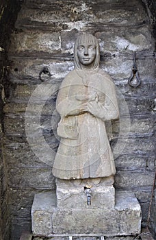 Niche, in stone blocks, with a statuette inside depicting a woman, in Vergemoli.