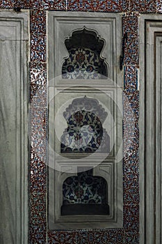 Niches with oriental ornaments in the wall in the Ottoman palace. Close-up. Vertical